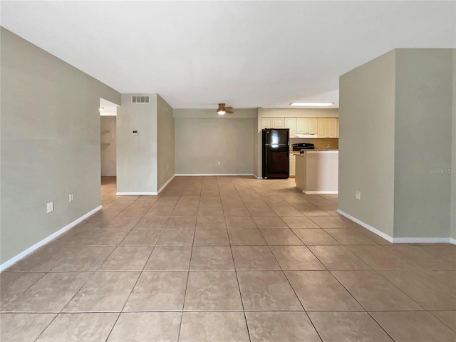 unfurnished living room featuring light tile patterned floors, baseboards, and visible vents