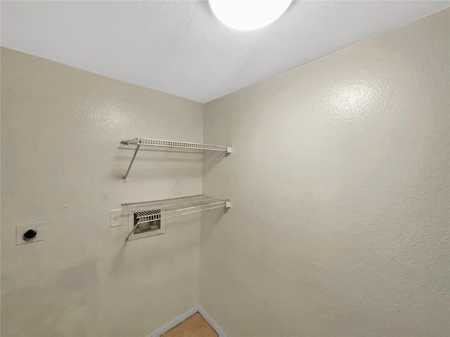 walk in closet featuring light tile patterned flooring