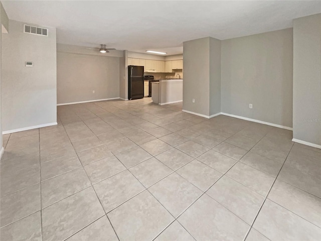 unfurnished living room featuring visible vents, baseboards, and light tile patterned floors