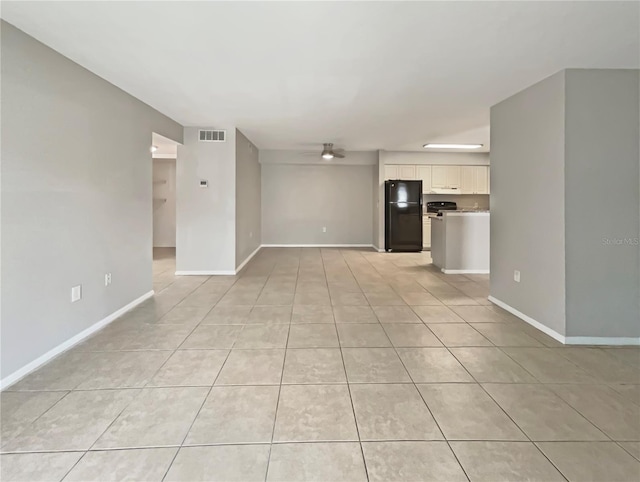 unfurnished living room featuring baseboards, ceiling fan, light tile patterned flooring, and visible vents