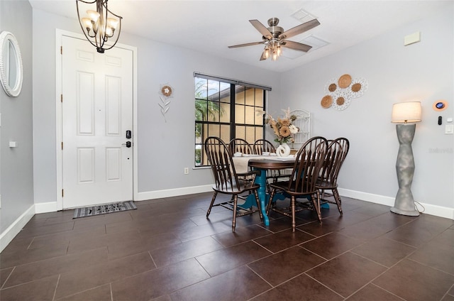 dining room with baseboards and ceiling fan with notable chandelier