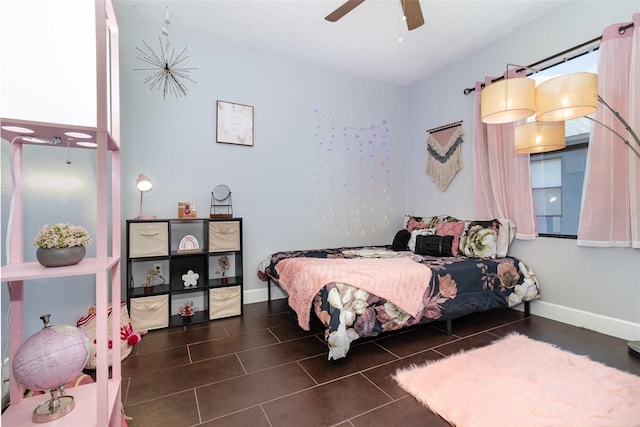 bedroom featuring baseboards, a ceiling fan, and tile patterned floors