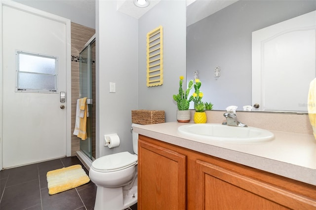 full bathroom with vanity, a stall shower, tile patterned floors, and toilet