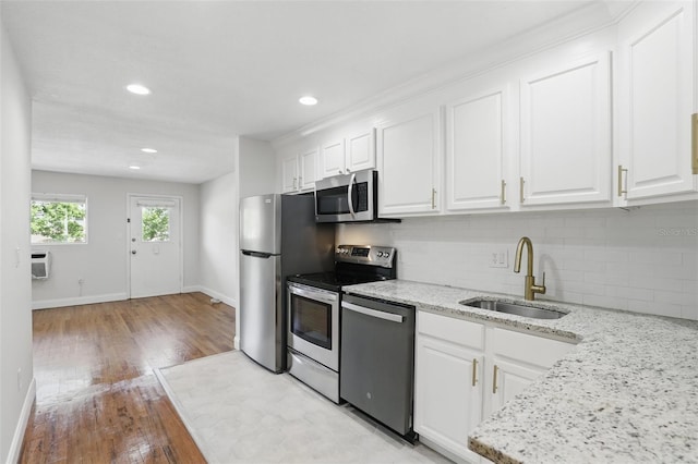 320 Lakeview St Unit 222, Orlando, FL 32804 - kitchen with appliances with stainless steel finishes, a sink, tasteful backsplash, white cabinets, and recessed lighting