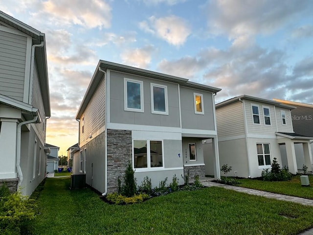1999 Iorio St, Saint Cloud, FL 34771 - view of front of property with a lawn, stucco siding, and stone siding