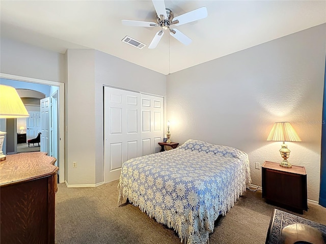 bedroom featuring visible vents, a closet, a ceiling fan, arched walkways, and carpet flooring