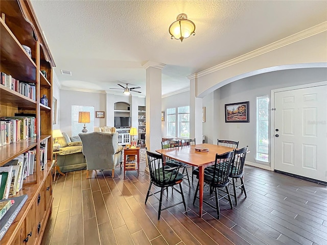 dining room with visible vents, ornamental molding, dark wood-style flooring, and ceiling fan