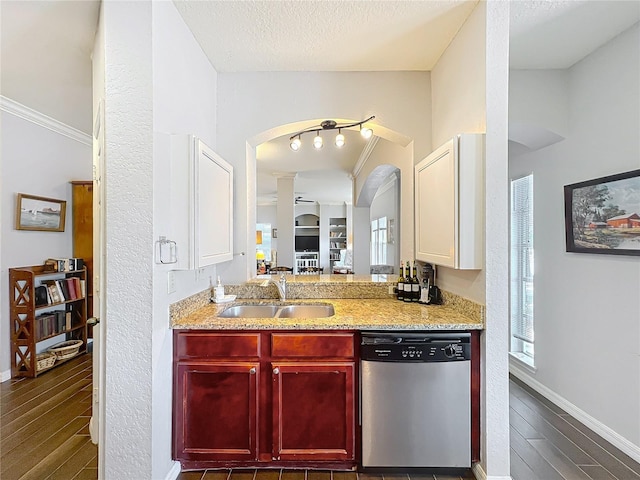 kitchen with arched walkways, dishwasher, a sink, dark wood-style floors, and reddish brown cabinets
