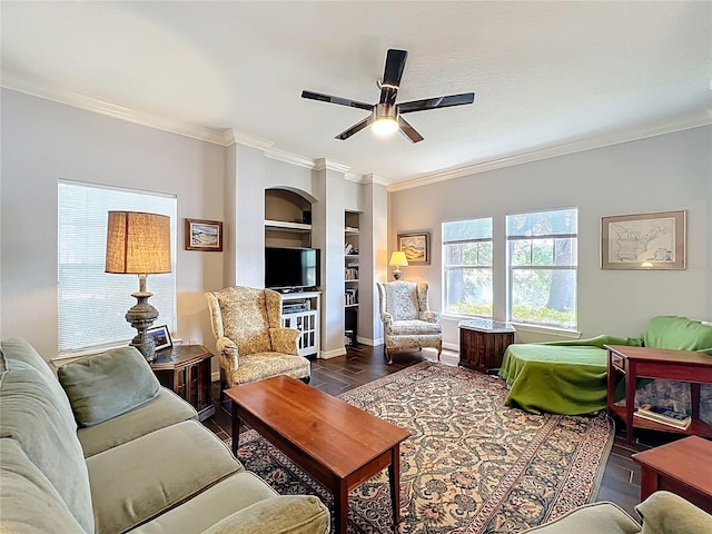 living area featuring crown molding, built in features, baseboards, ceiling fan, and dark wood finished floors