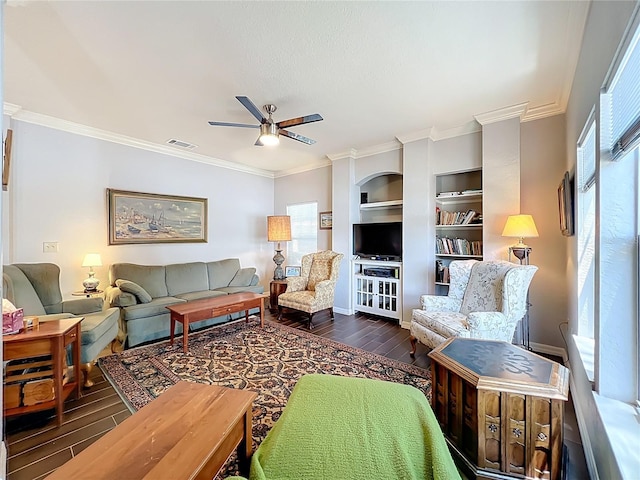 living area with a ceiling fan, visible vents, ornamental molding, and wood finished floors