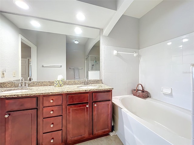 bathroom with an enclosed shower, double vanity, a sink, and a bath