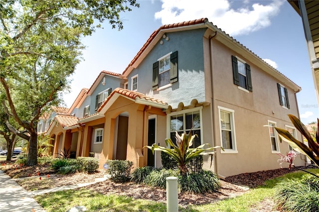 7348 Yoder St, Windermere, FL 34786 - view of side of home featuring a tiled roof and stucco siding