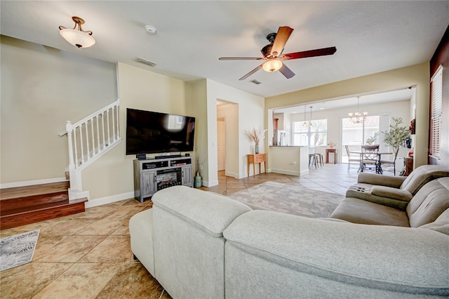 7348 Yoder St, Windermere, FL 34786 - living room featuring stairs, light tile patterned flooring, visible vents, and ceiling fan with notable chandelier