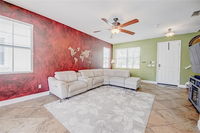 7348 Yoder St, Windermere, FL 34786 - living room with light tile patterned flooring, ceiling fan, an accent wall, baseboards, and visible vents