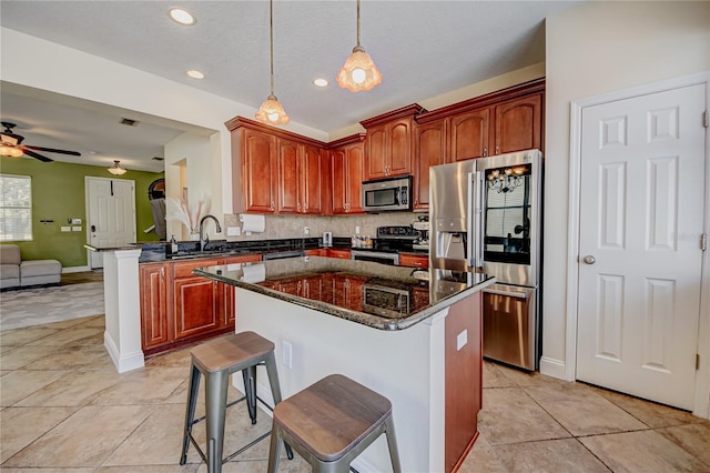 7348 Yoder St, Windermere, FL 34786 - kitchen featuring appliances with stainless steel finishes, a sink, a peninsula, open floor plan, and backsplash