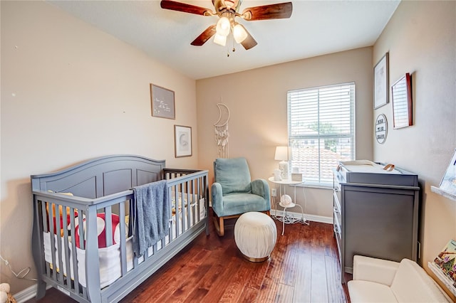 7348 Yoder St, Windermere, FL 34786 - bedroom with wood-type flooring, a ceiling fan, a crib, and baseboards