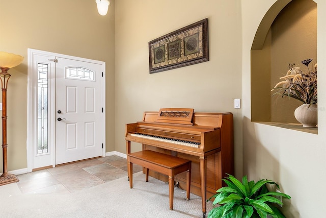 entryway with arched walkways and baseboards