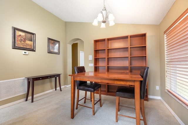 office featuring arched walkways, lofted ceiling, a chandelier, and light carpet