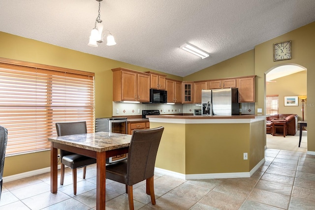 kitchen featuring a textured ceiling, arched walkways, vaulted ceiling, black appliances, and glass insert cabinets