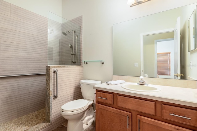 bathroom featuring vanity, walk in shower, and toilet