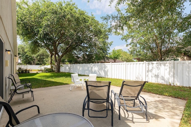 view of patio with a fenced backyard and outdoor dining space