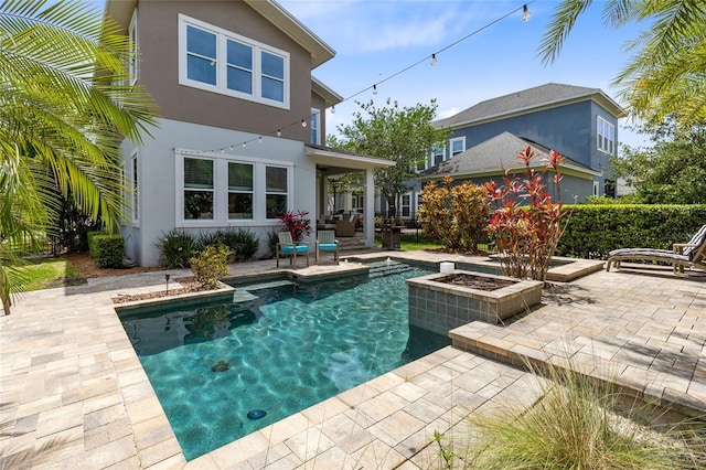 8263 Bellow St, Orlando, FL 32827 - back of property featuring a patio area, stucco siding, and an outdoor pool