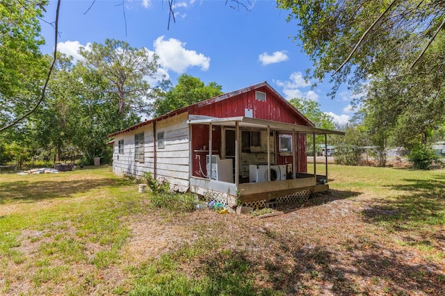 view of side of home with a yard