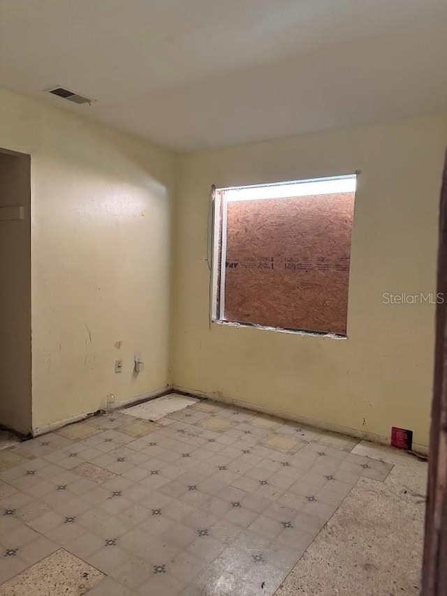empty room featuring tile patterned floors and visible vents