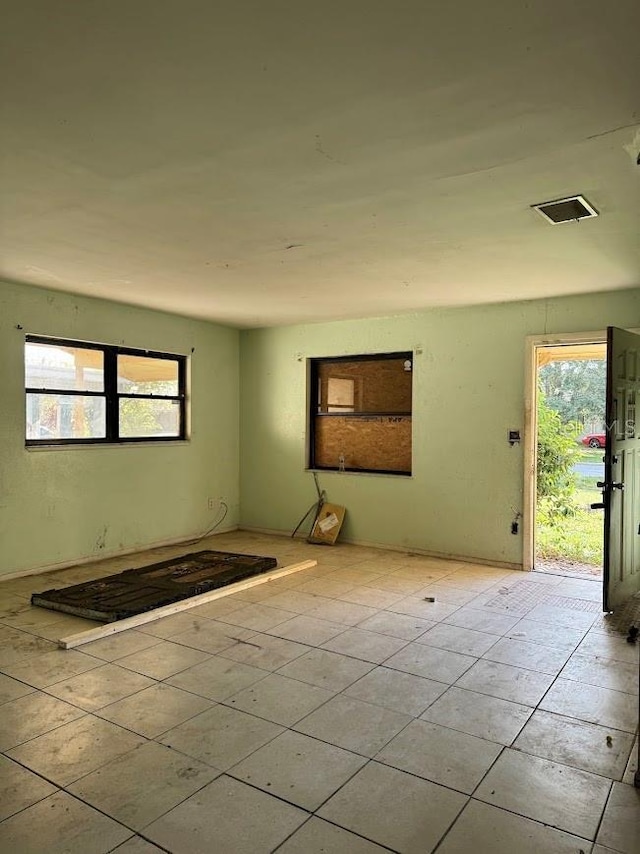 spare room with visible vents and tile patterned floors