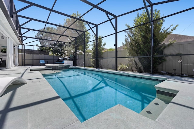 view of pool with a fenced backyard, a patio area, a lanai, and a pool with connected hot tub