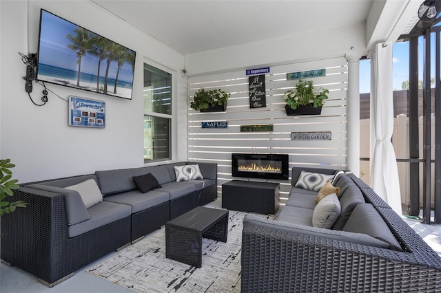 living room featuring a glass covered fireplace