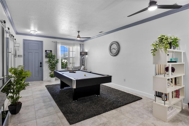 rec room with crown molding, ceiling fan, a textured ceiling, billiards, and light tile patterned floors