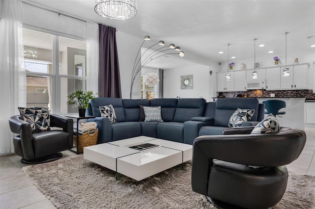 living room featuring an inviting chandelier and light tile patterned floors
