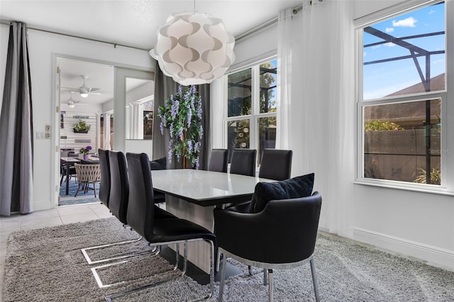 dining space with baseboards and a notable chandelier