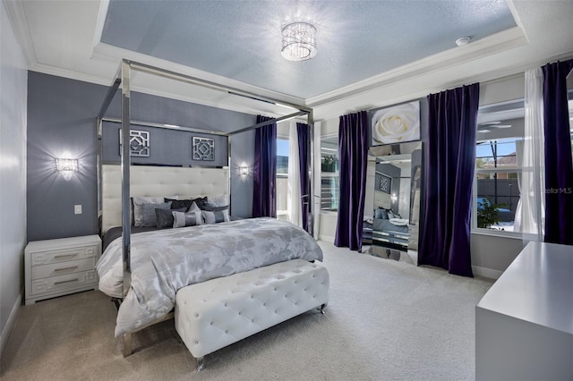 bedroom featuring carpet floors, baseboards, ornamental molding, and a raised ceiling