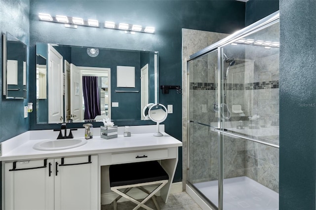 full bath featuring vanity and a shower stall