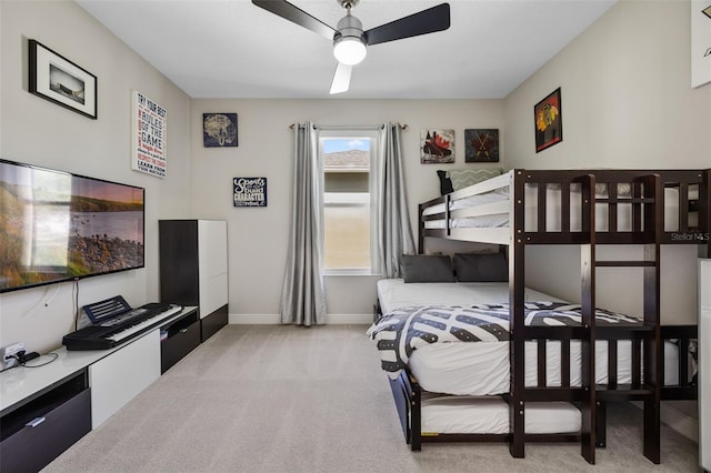 carpeted bedroom with baseboards and a ceiling fan