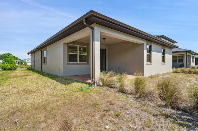 3128 Oxbow Ct, Harmony, FL 34773 - view of property exterior with a lawn and stucco siding