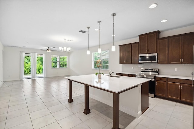 3128 Oxbow Ct, Harmony, FL 34773 - kitchen featuring visible vents, light countertops, tasteful backsplash, a sink, and appliances with stainless steel finishes