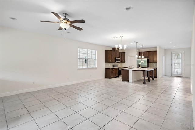 3128 Oxbow Ct, Harmony, FL 34773 - unfurnished living room featuring baseboards, recessed lighting, ceiling fan with notable chandelier, and light tile patterned floors