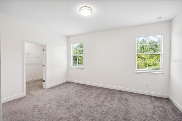 3128 Oxbow Ct, Harmony, FL 34773 - unfurnished bedroom featuring carpet flooring, baseboards, a spacious closet, and a closet