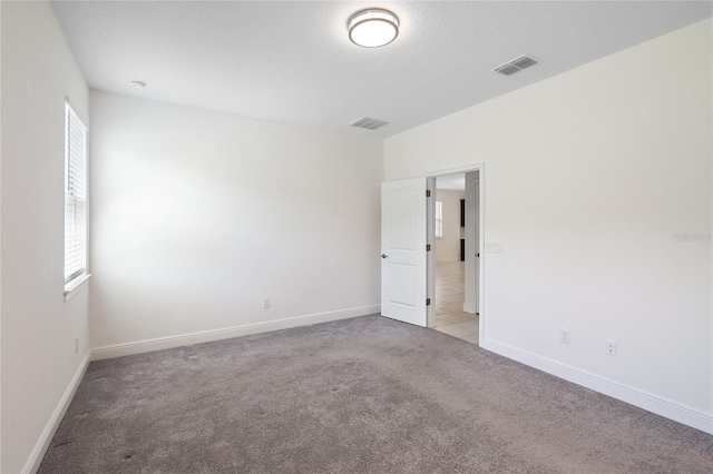 3128 Oxbow Ct, Harmony, FL 34773 - empty room featuring visible vents, light carpet, and a wealth of natural light