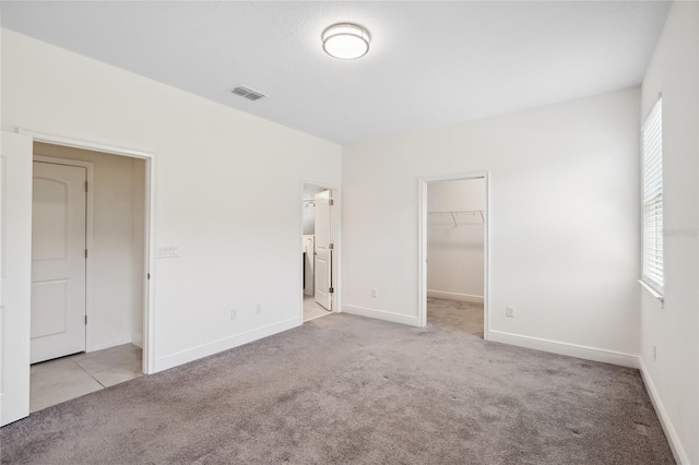 3128 Oxbow Ct, Harmony, FL 34773 - unfurnished bedroom with visible vents, carpet floors, a closet, baseboards, and a spacious closet