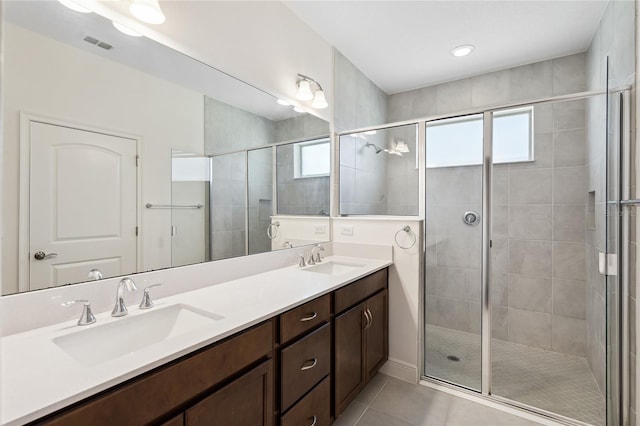 3128 Oxbow Ct, Harmony, FL 34773 - bathroom with a sink, tile patterned flooring, a shower stall, and visible vents