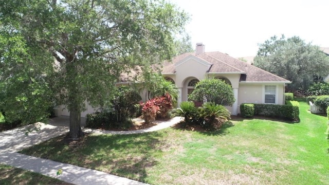 13250 Meergate Cir, Orlando, FL 32837 - view of property exterior featuring a yard, a chimney, and stucco siding