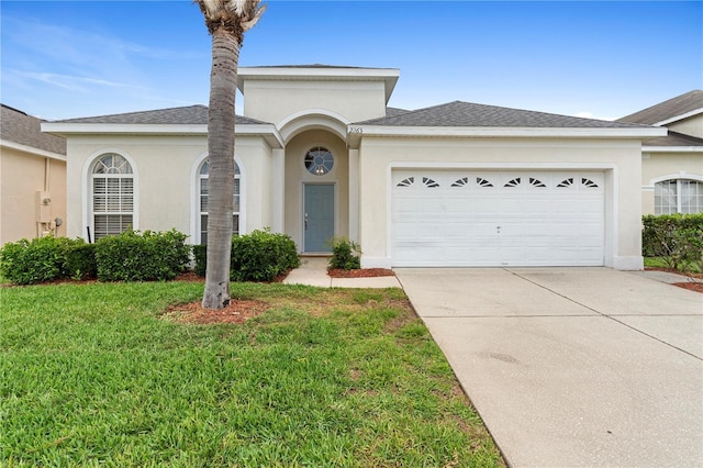 view of front of house featuring concrete driveway, a garage, a front lawn, and stucco siding