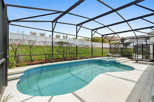 view of pool with a lanai, a patio, and a pool with connected hot tub