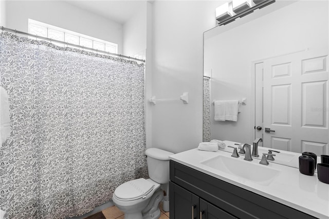 full bath featuring toilet, tile patterned floors, and vanity
