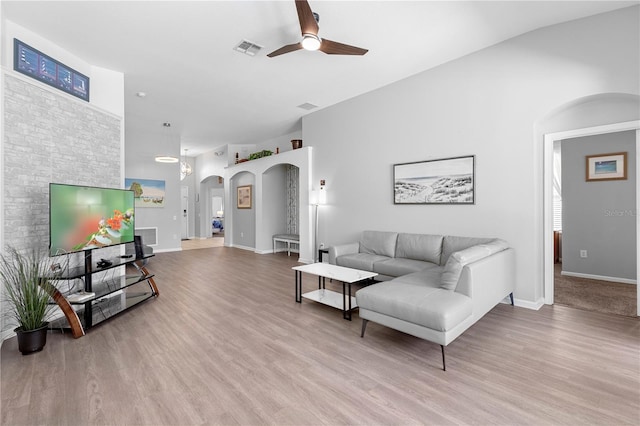 2263 Wyndham Palms Way, Kissimmee, FL 34747 - living area with arched walkways, a ceiling fan, light wood-style flooring, and baseboards