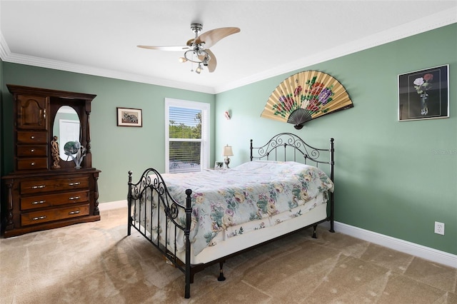carpeted bedroom featuring crown molding, baseboards, and a ceiling fan
